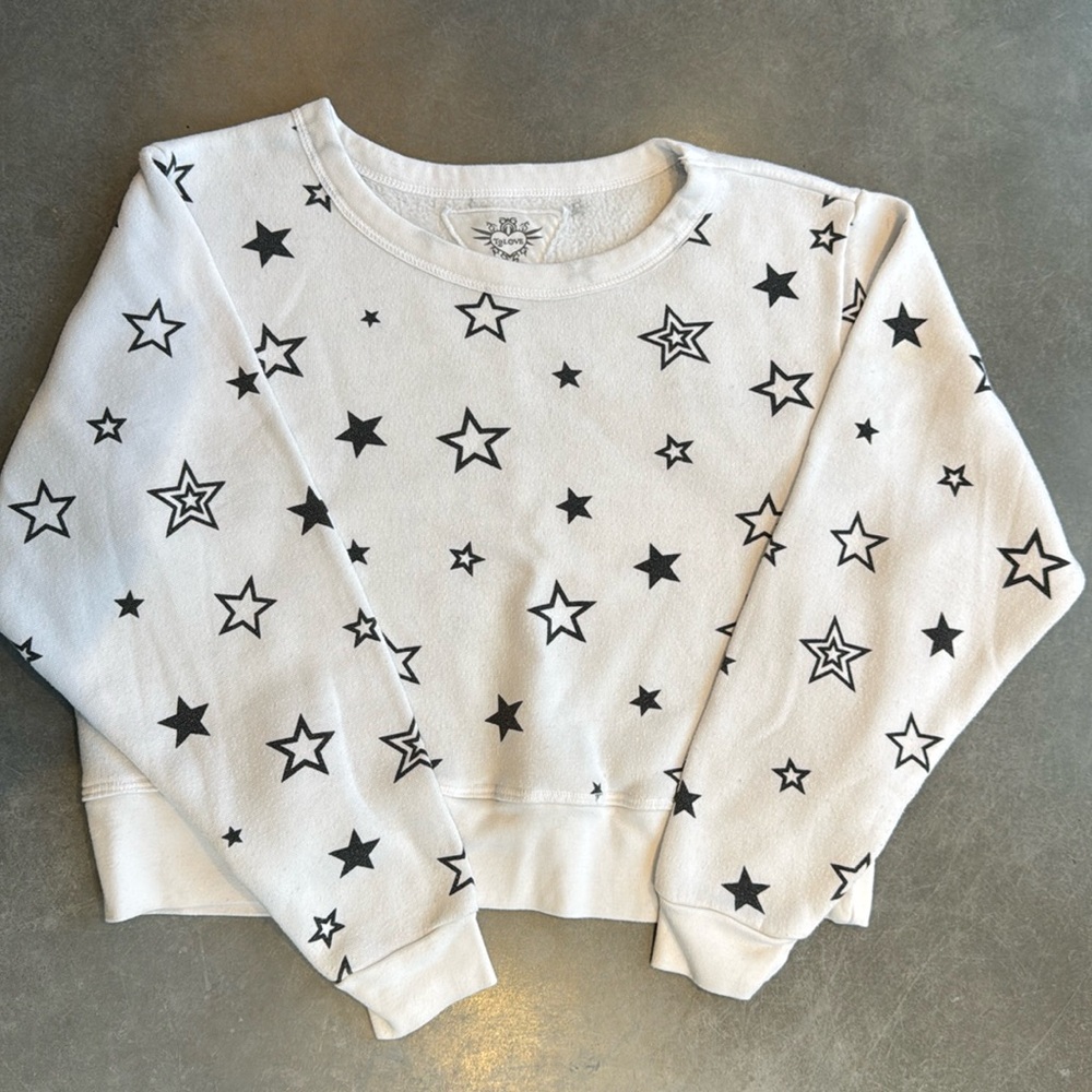 White sweatshirt with black stars. Worn but in great condition.